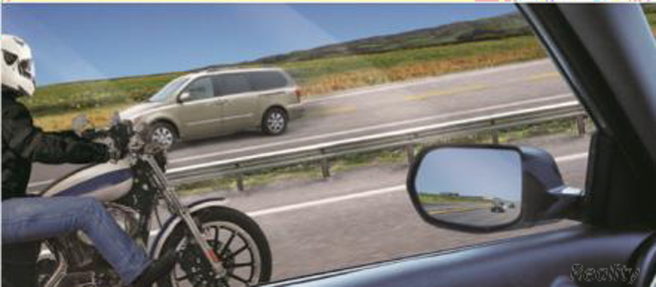 Image of a motorcycle passing a vehicle through the lens of the other vehicle