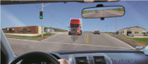 Image of a CDL truck at an intersection with a motorcycle as a ghost image in front of it