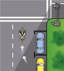 Image of a motorcycle in the left lane far from the parked car